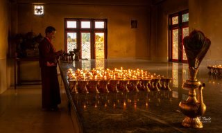 Lamps being lit for Buddha Lamps being lit for Buddha