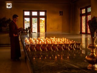Lamps being lit for Buddha
