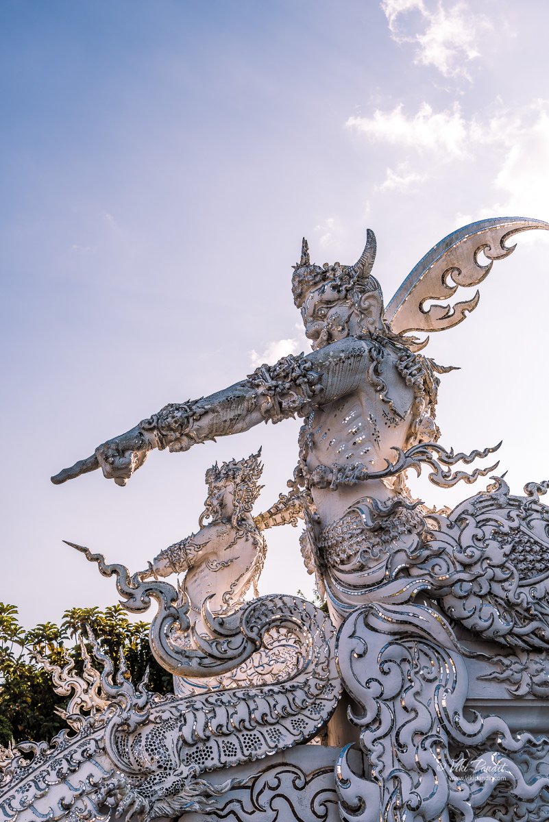 Guardians standing guard at the entrance of Wat Rong Khun